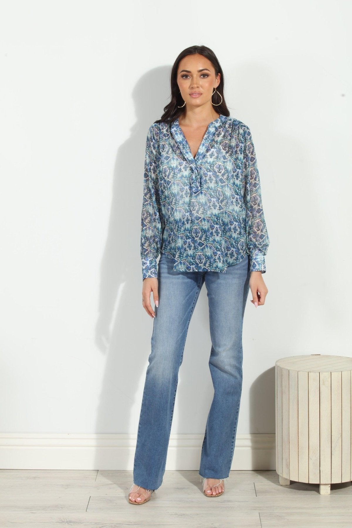 blue printed blouse on woman in denim pants