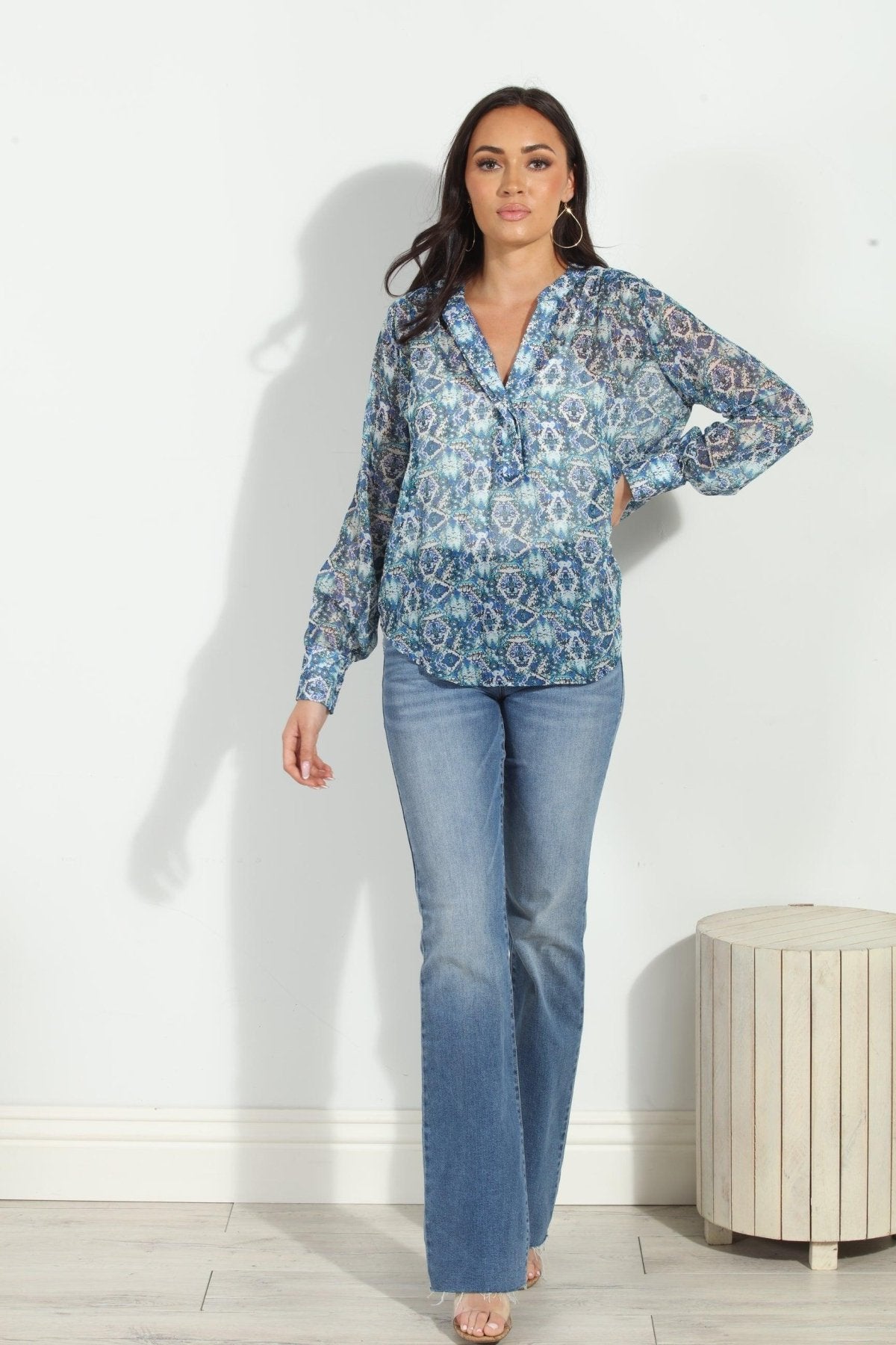 blue printed blouse on woman in denim pants