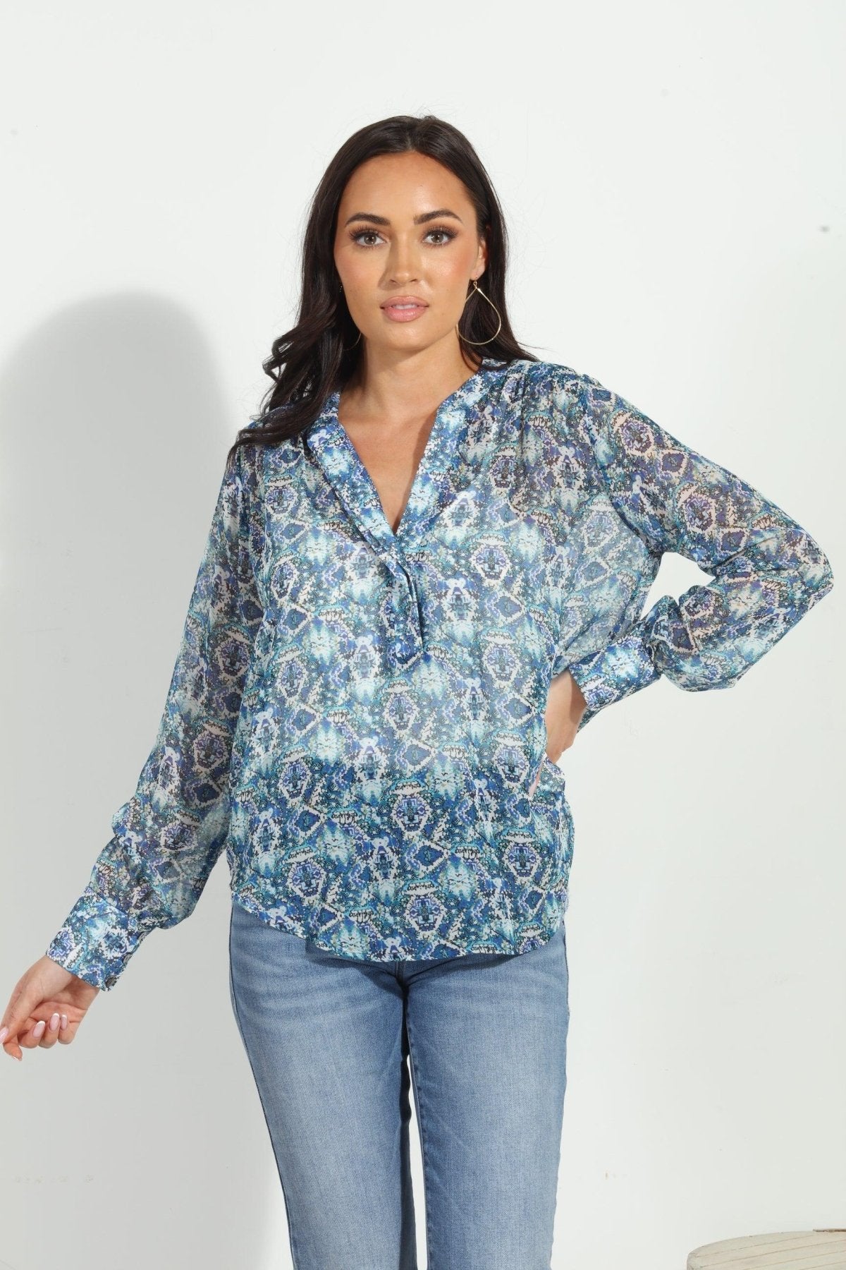 blue printed blouse on woman in denim pants