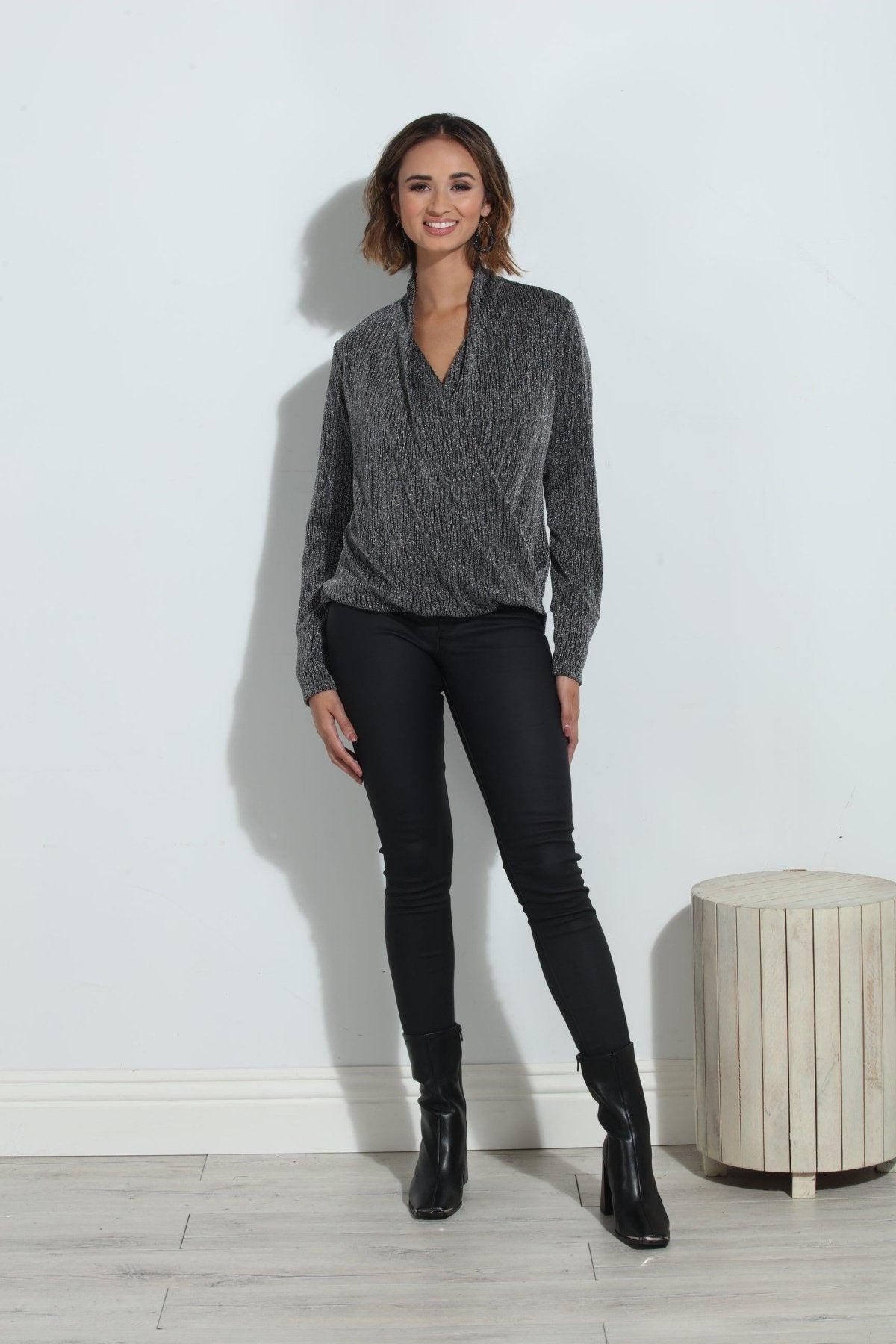 silver and black long sleeve blouse on woman in black pants and black boots