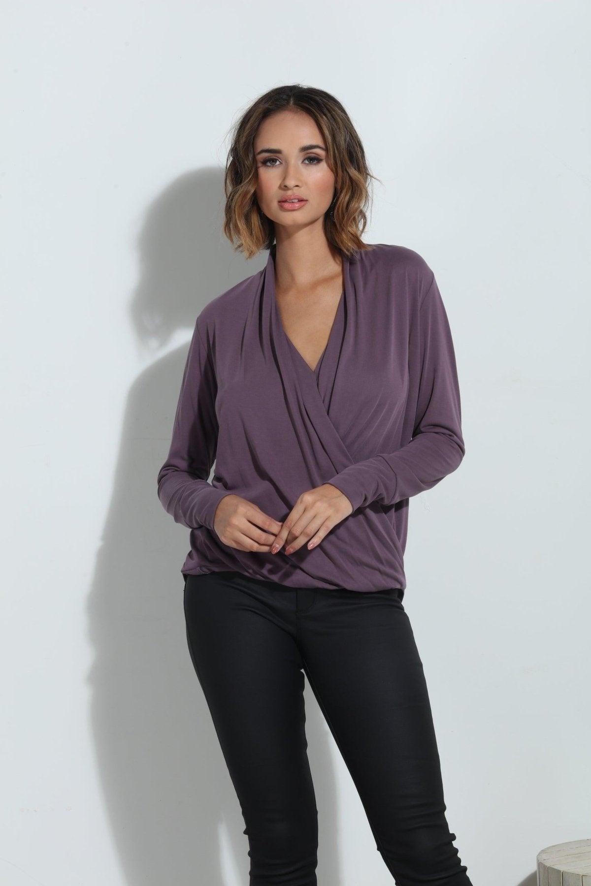purple long sleeve blouse on woman in black pants