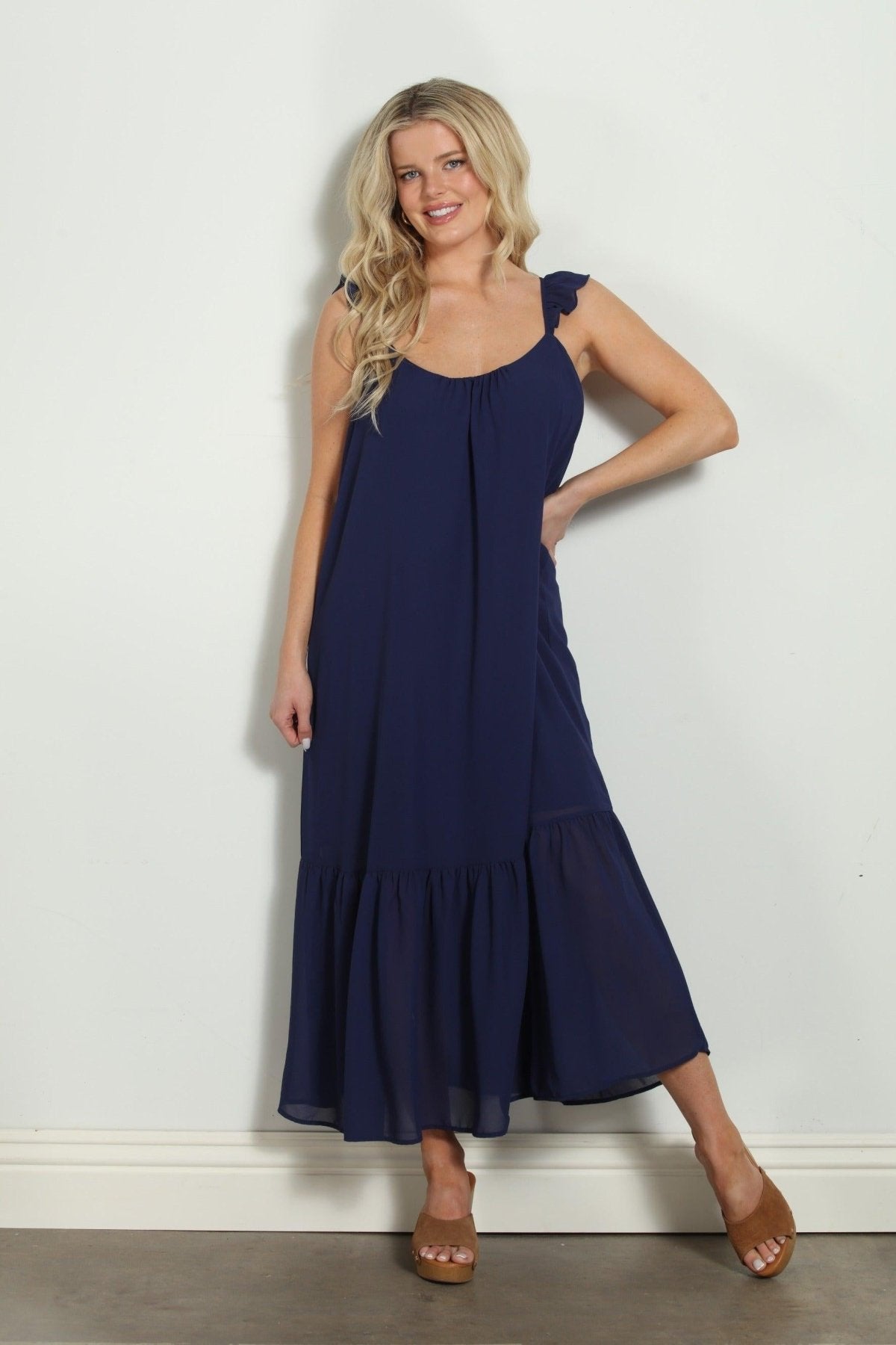woman in sleeveless navy maxi dress