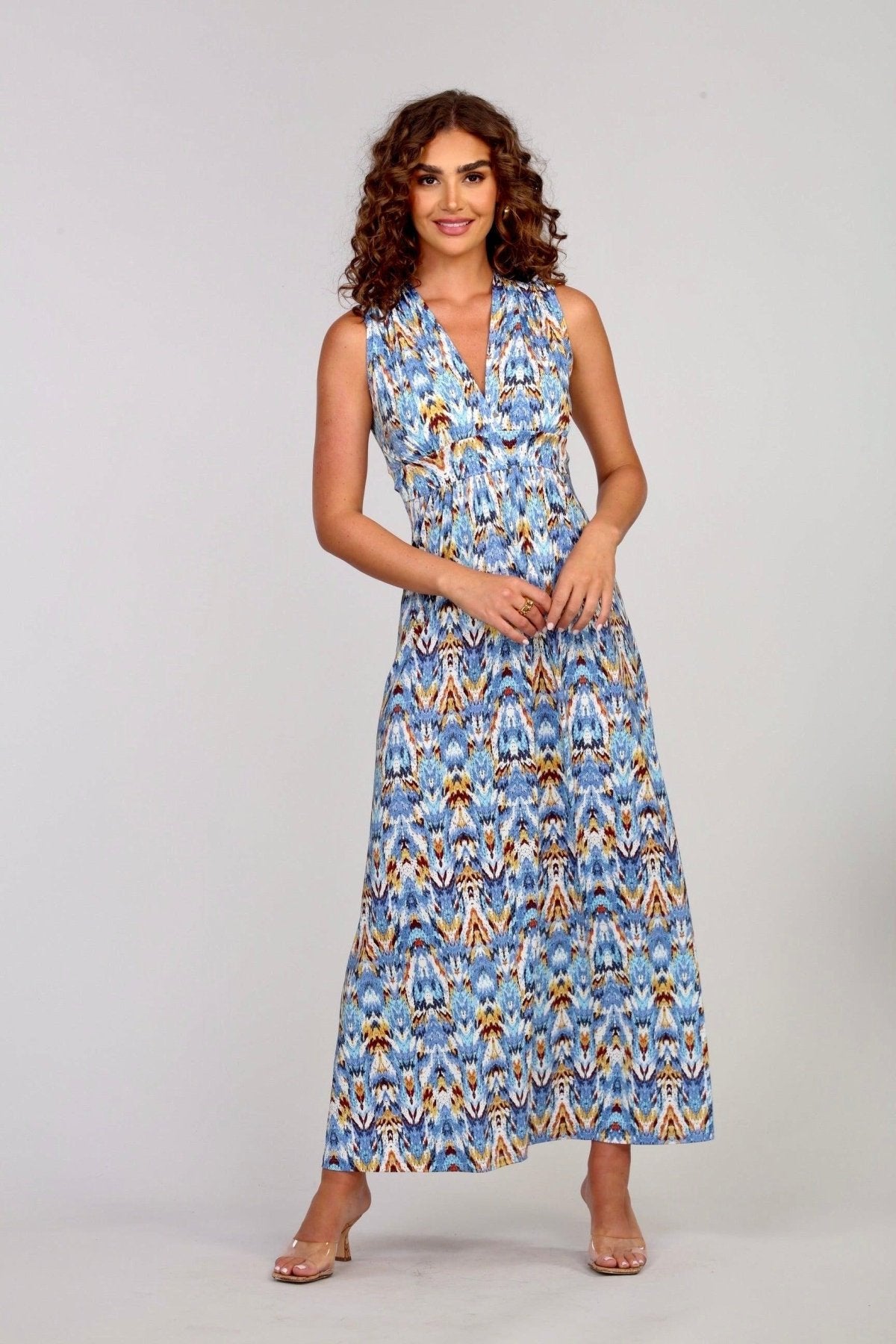 woman with curly hair wearing multicolored maxi dress