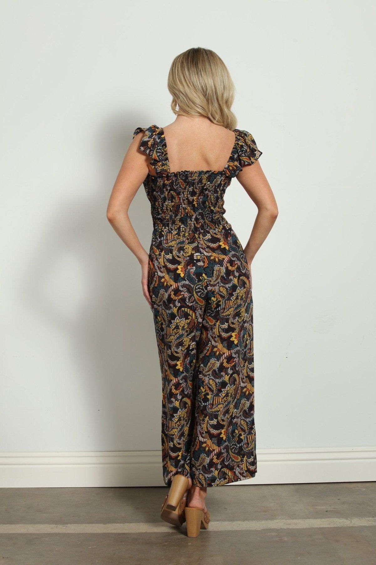 backside of woman in multicolored sleeveless jumpsuit