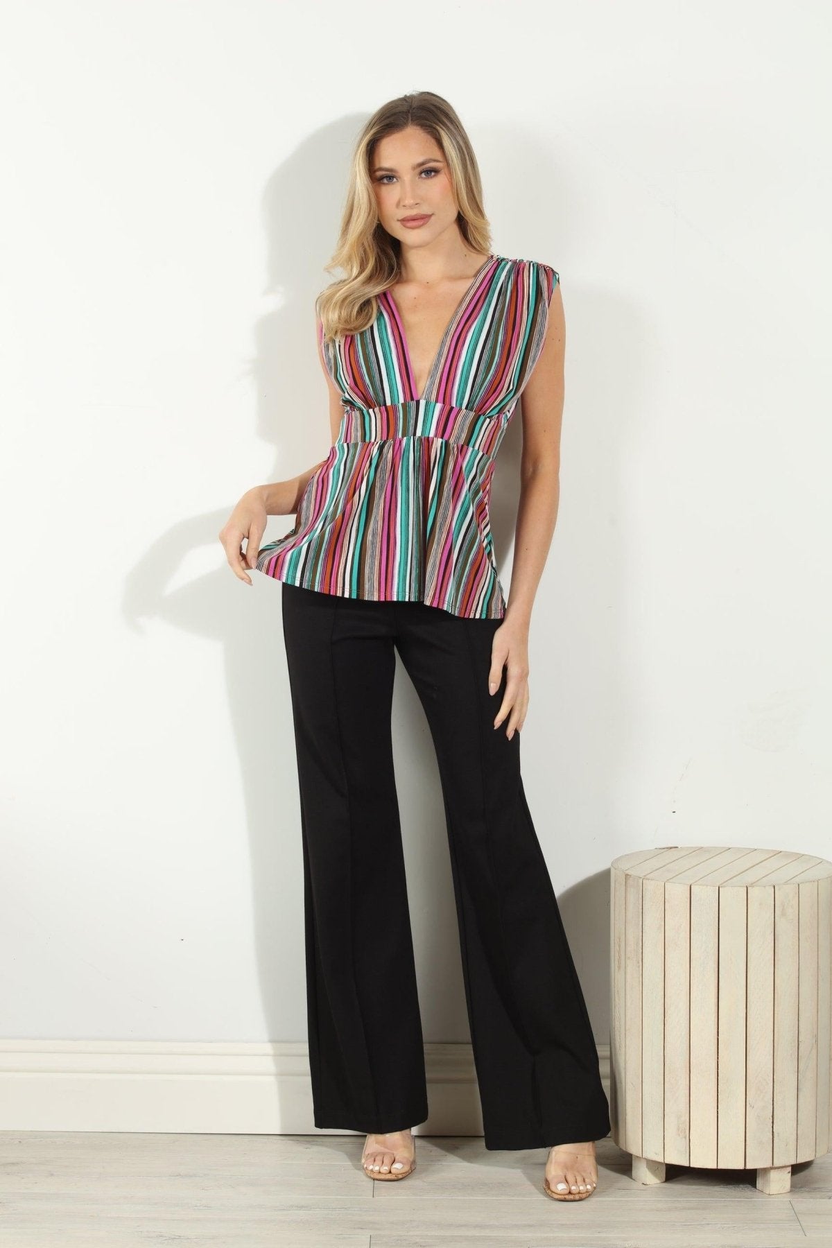 woman in multicolored sleeveless blouse and black pants