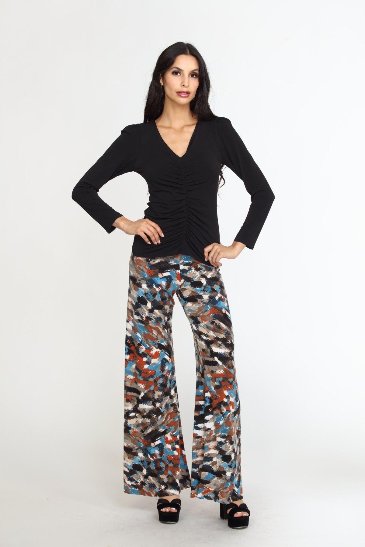 multicolored wideleg pants on woman in black heels and black long sleeve top