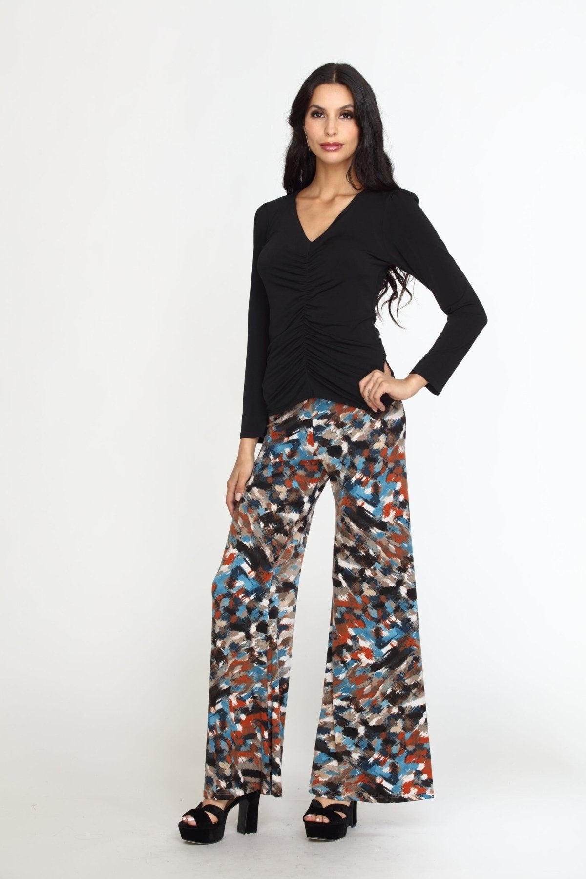 multicolored wideleg pants on woman in black heels and black long sleeve top