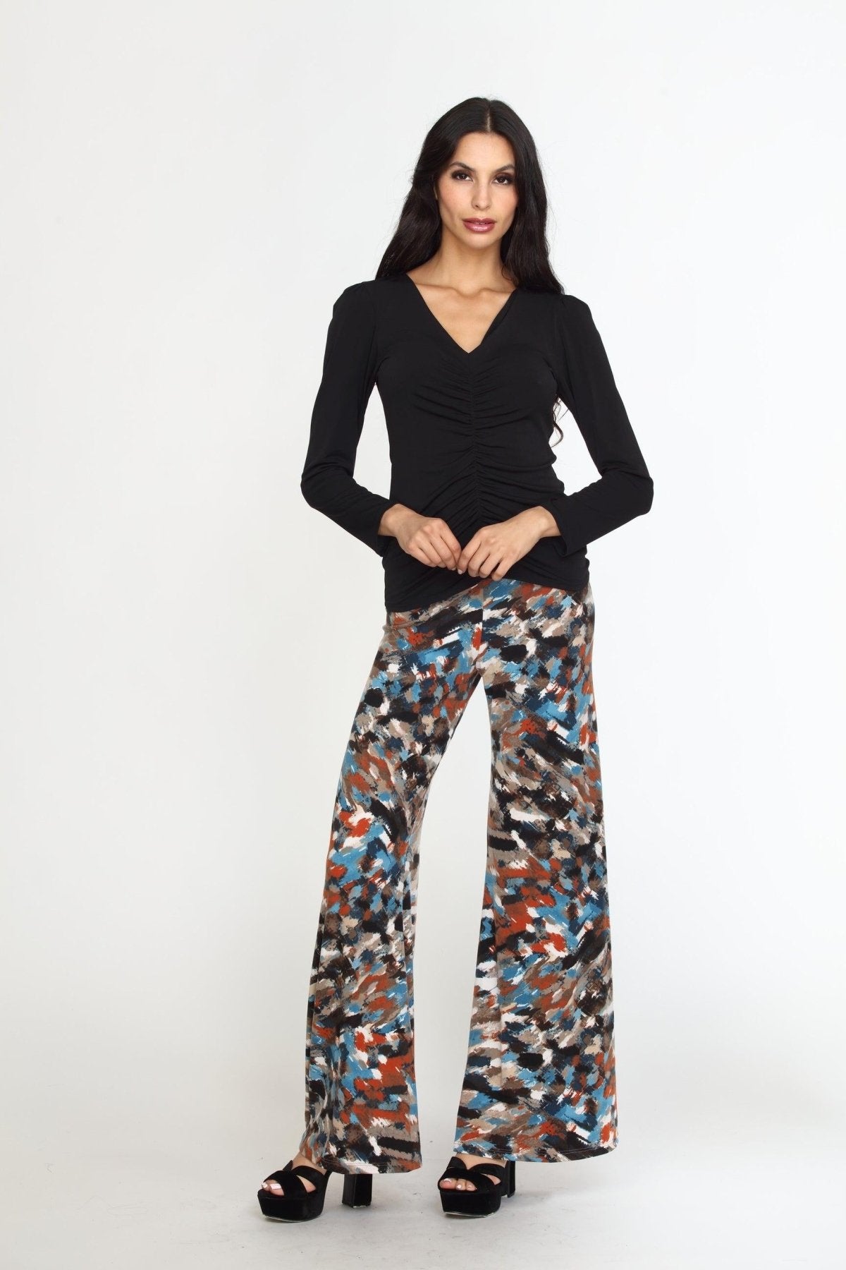 multicolored wideleg pants on woman in black heels and black long sleeve top