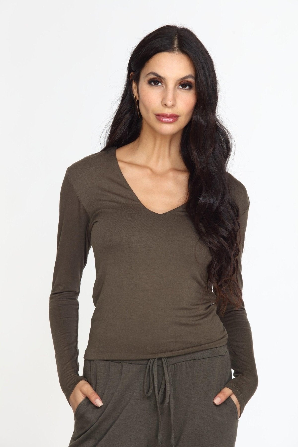 olive long sleeve vneck top on woman in olive pants