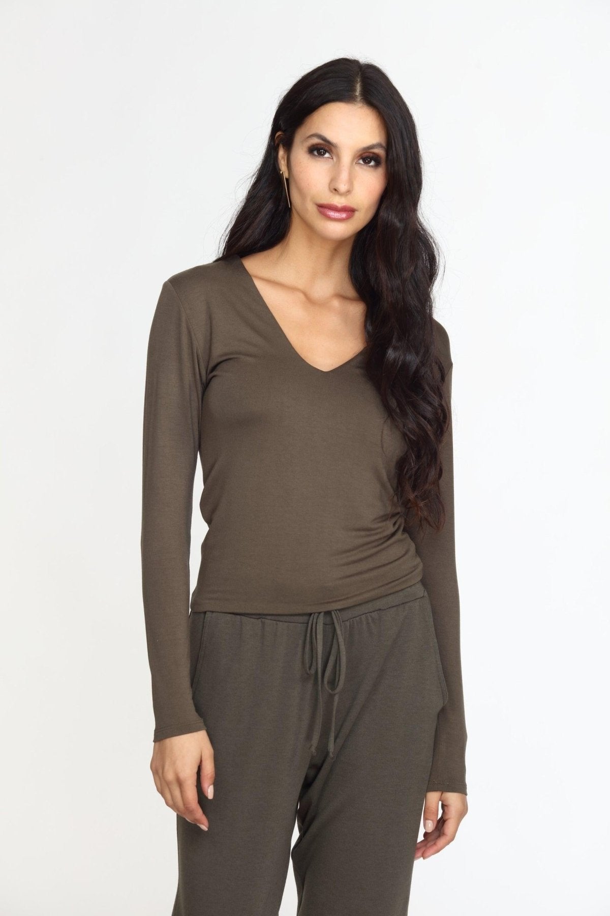 olive long sleeve vneck top on woman in olive pants