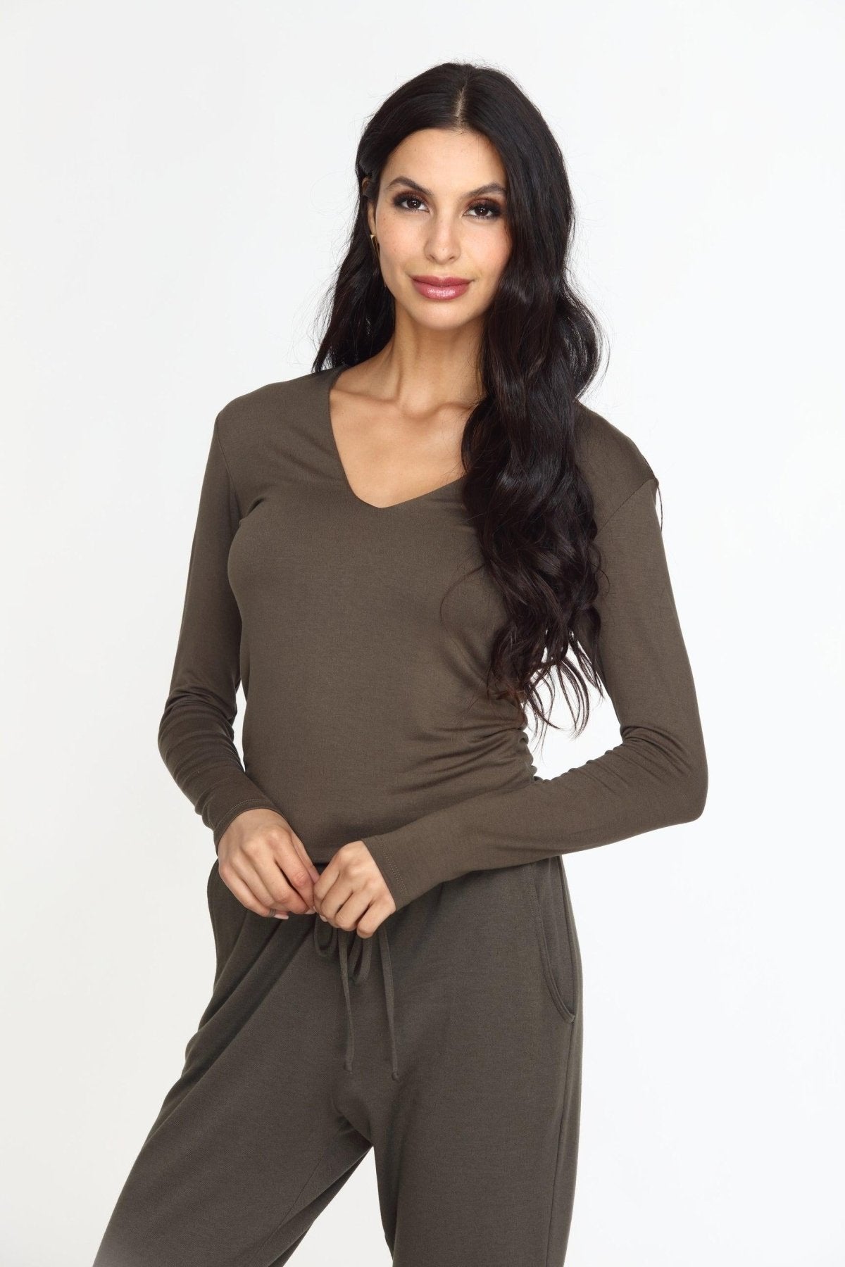 olive long sleeve vneck top on woman in olive pants