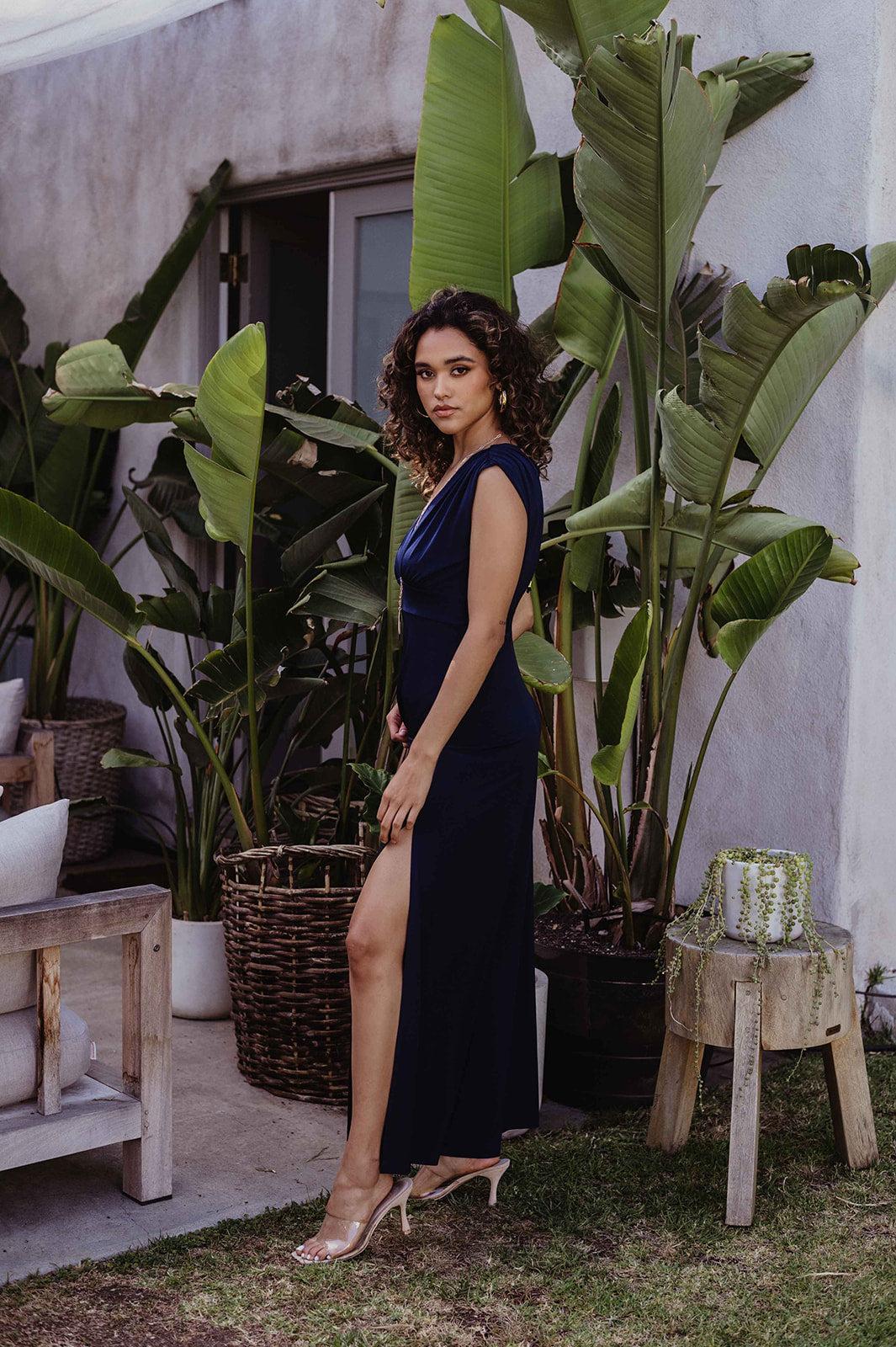 navy sleeveless maxi dress with deep neckline and side slit on woman
