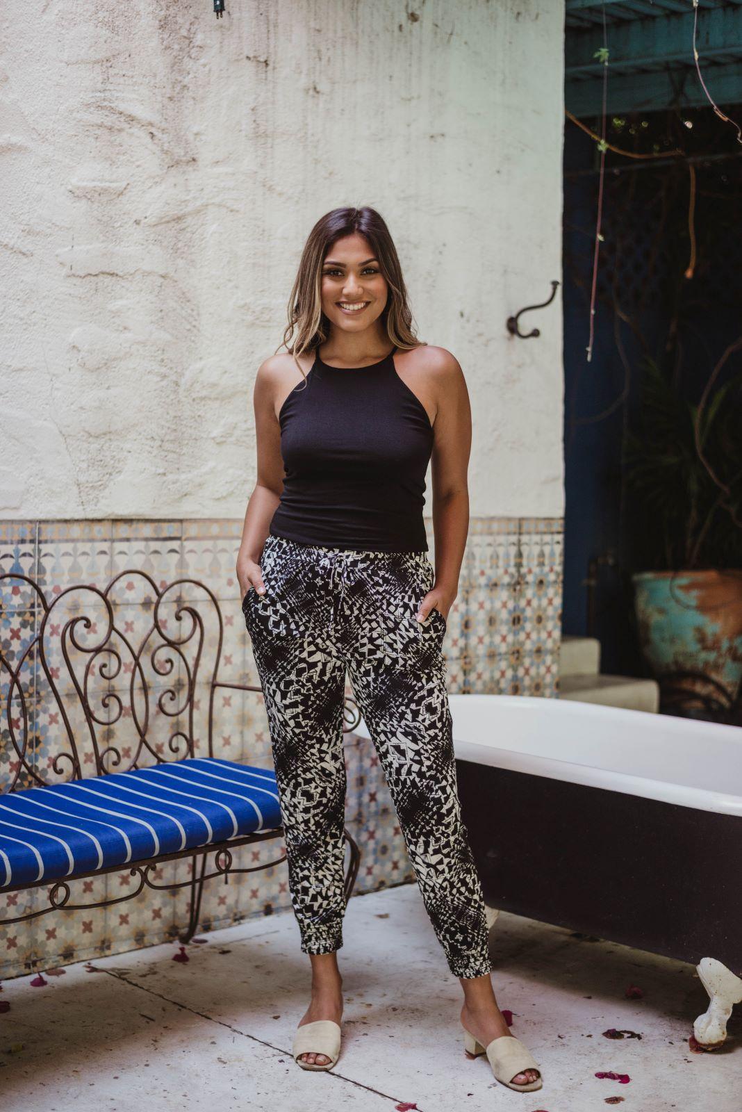black sleeveless tank top and printed tapered pants on woman
