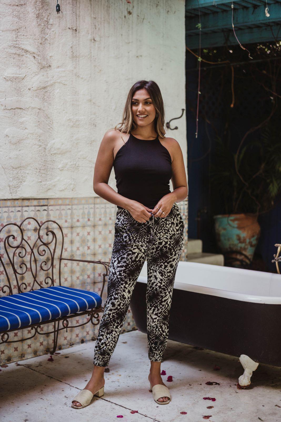 black sleeveless tank top and printed tapered pants on woman