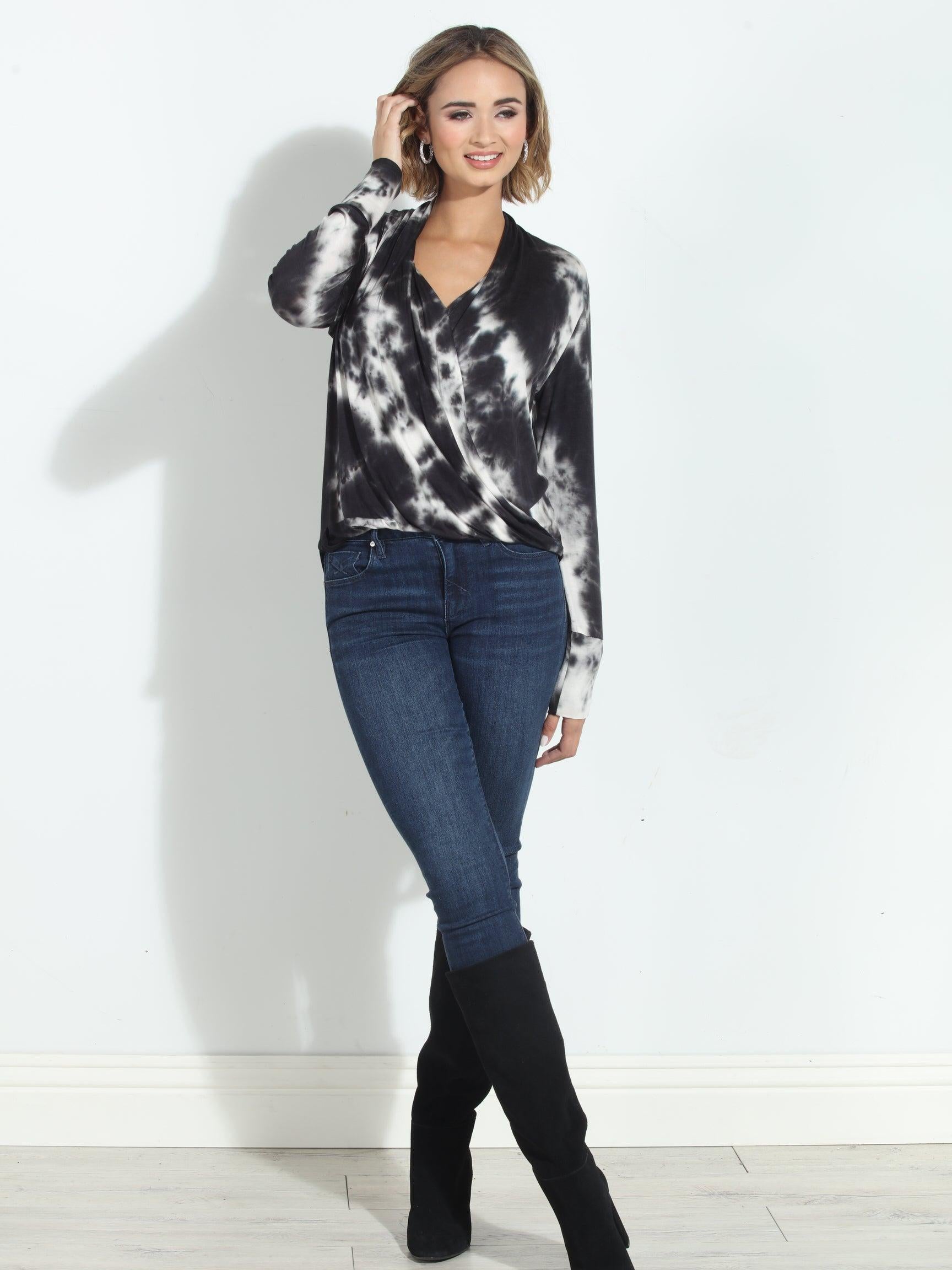black and white tie-died long sleeve blouse on woman in denim pants and black boots