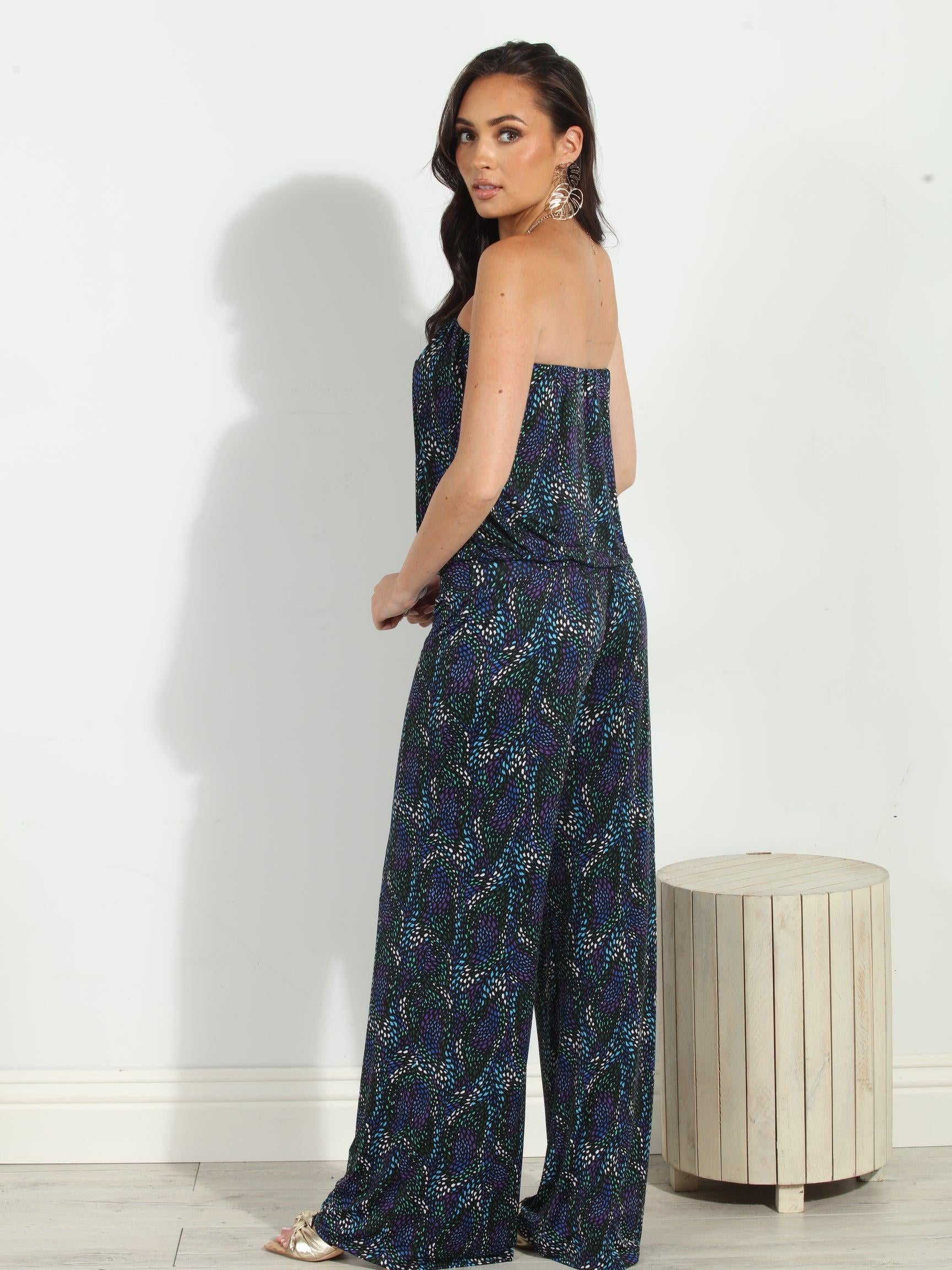 back side of multicolored strapless jumpsuit on woman
