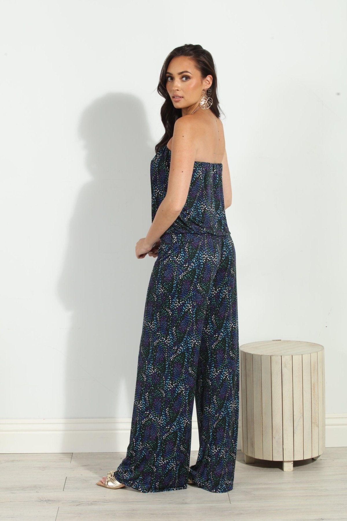 back side of multicolored strapless jumpsuit on woman