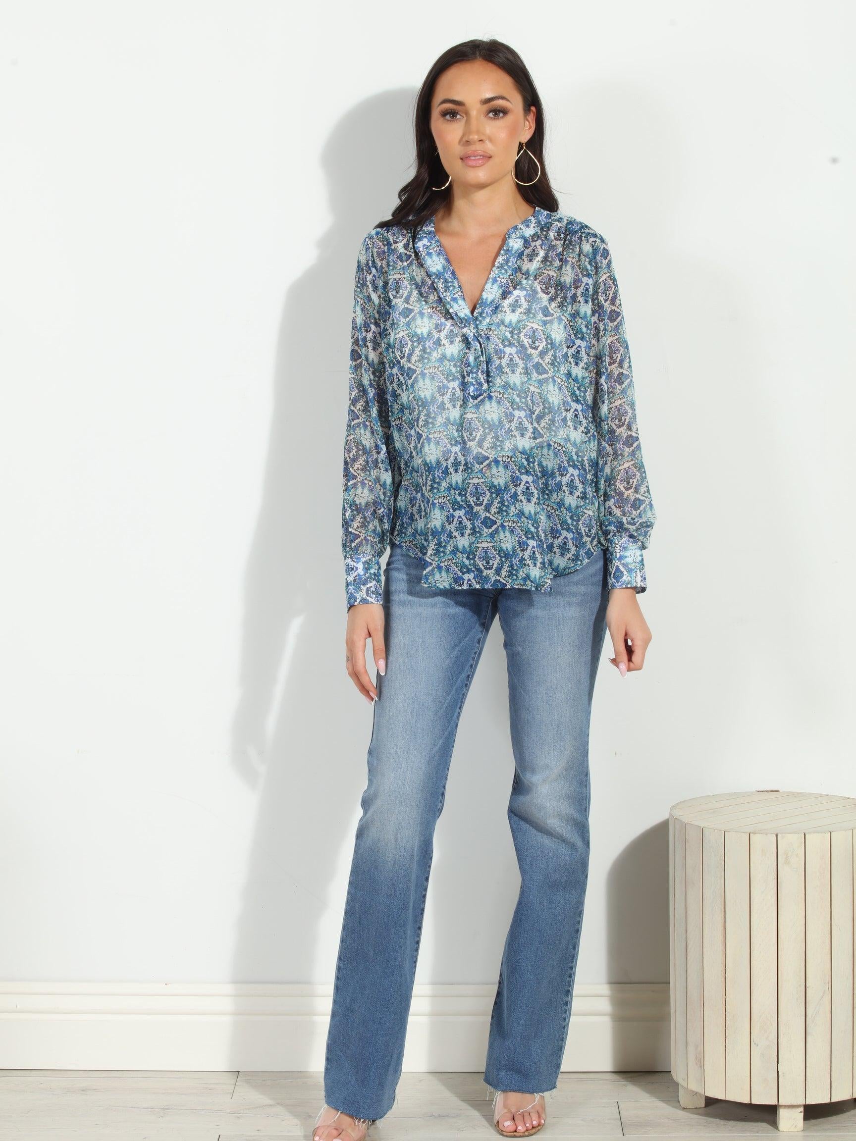 blue printed blouse on woman in denim pants