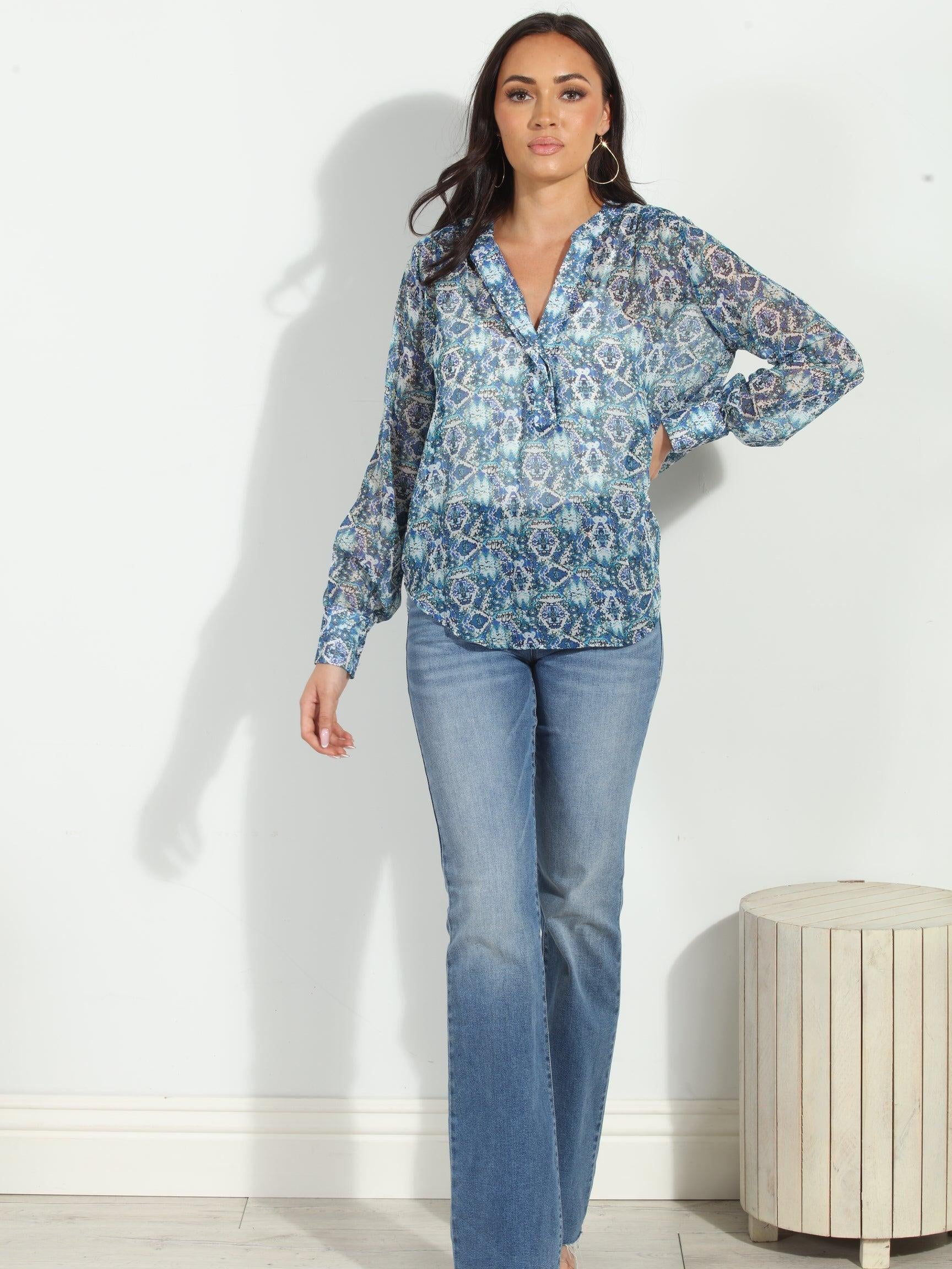 blue printed blouse on woman in denim pants