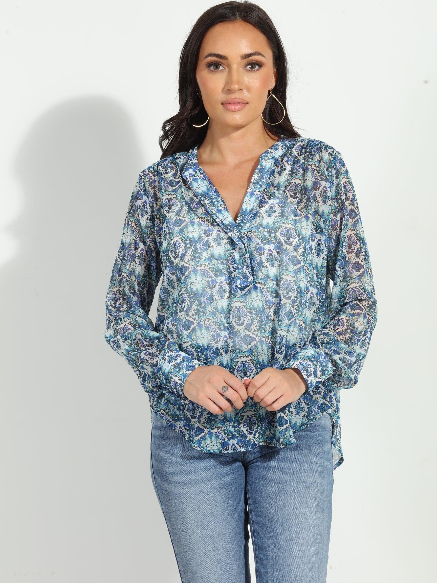 blue printed blouse on woman in denim pants