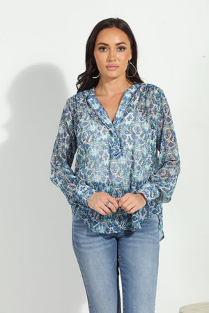 blue printed blouse on woman in denim pants