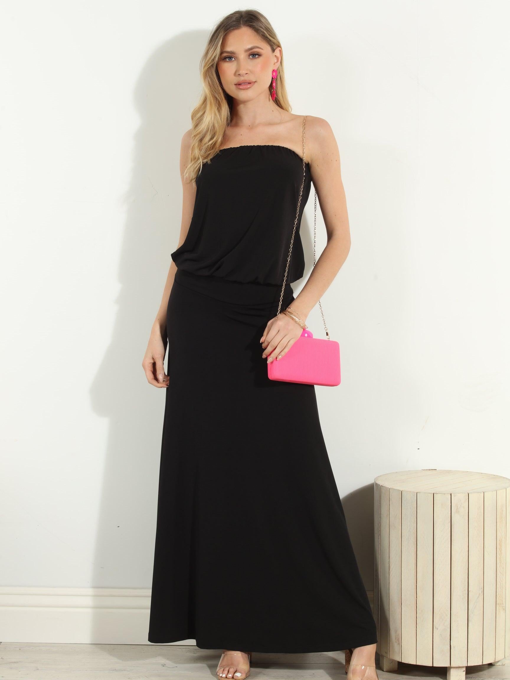 black strapless maxi dress on woman holding pink purse