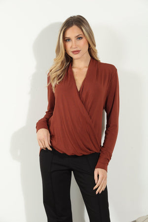 dark orange long sleeve blouse on woman in black pants
