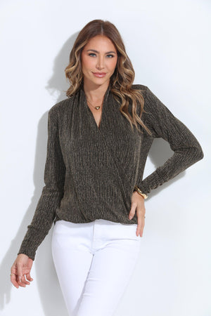 black and gold long sleeve top on woman in white pants