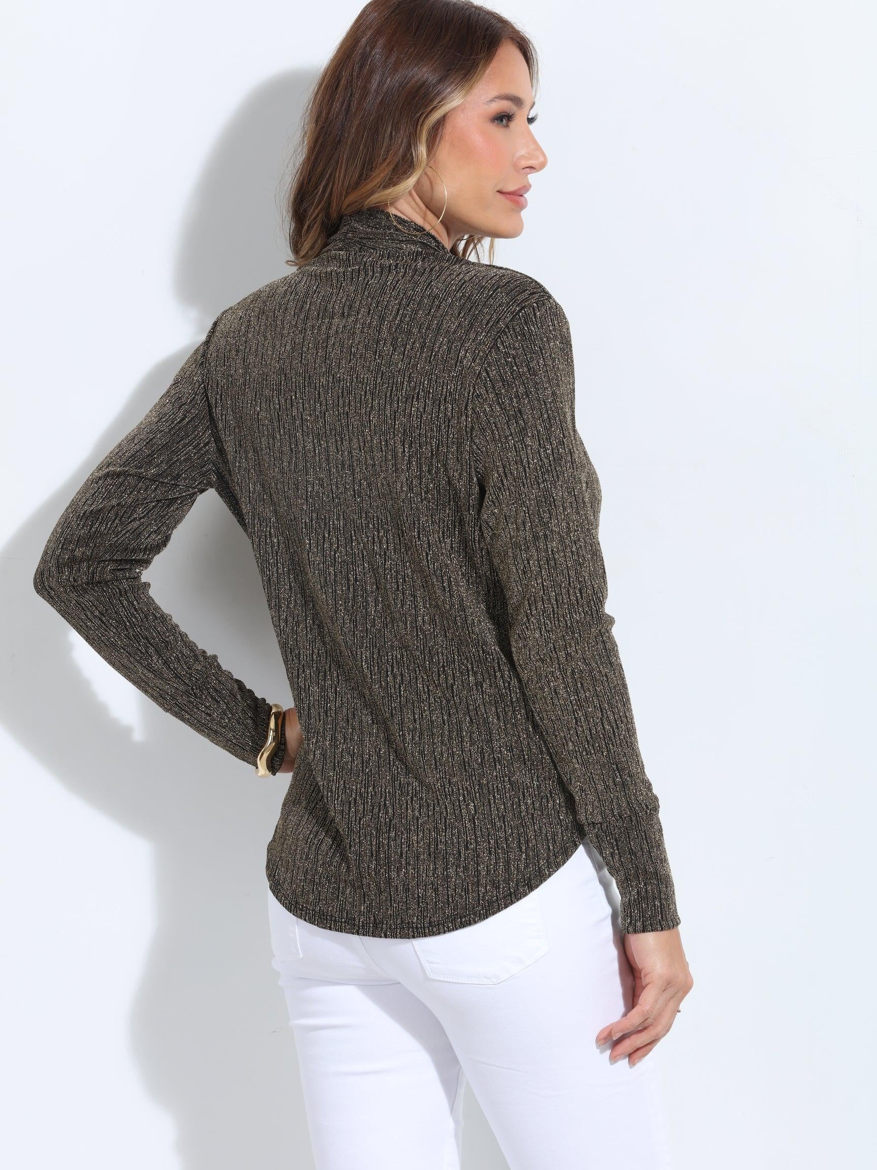 backside of black and gold long sleeve top on woman in white pants