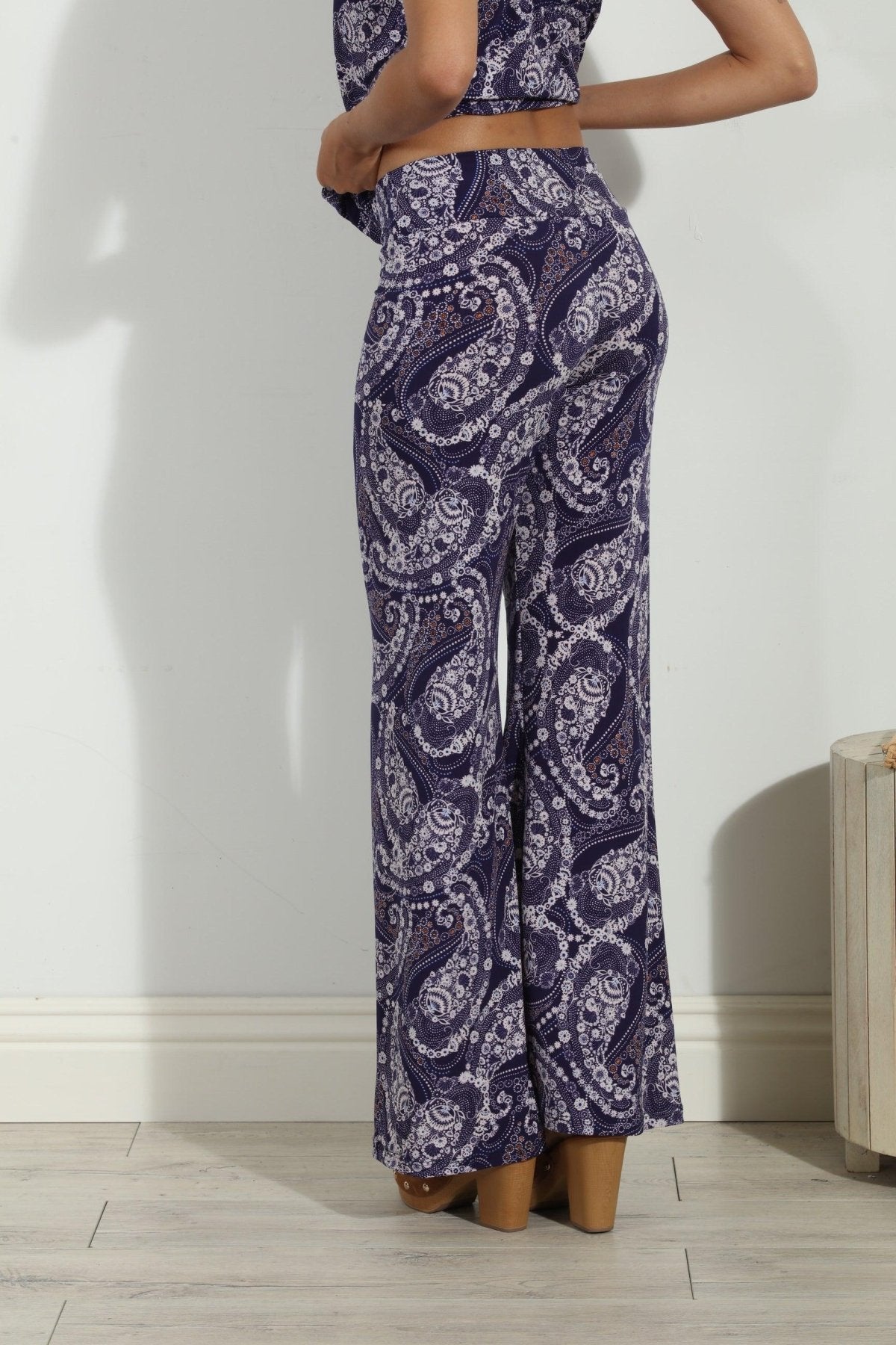 back side of blue and white paisley wide leg pants on body