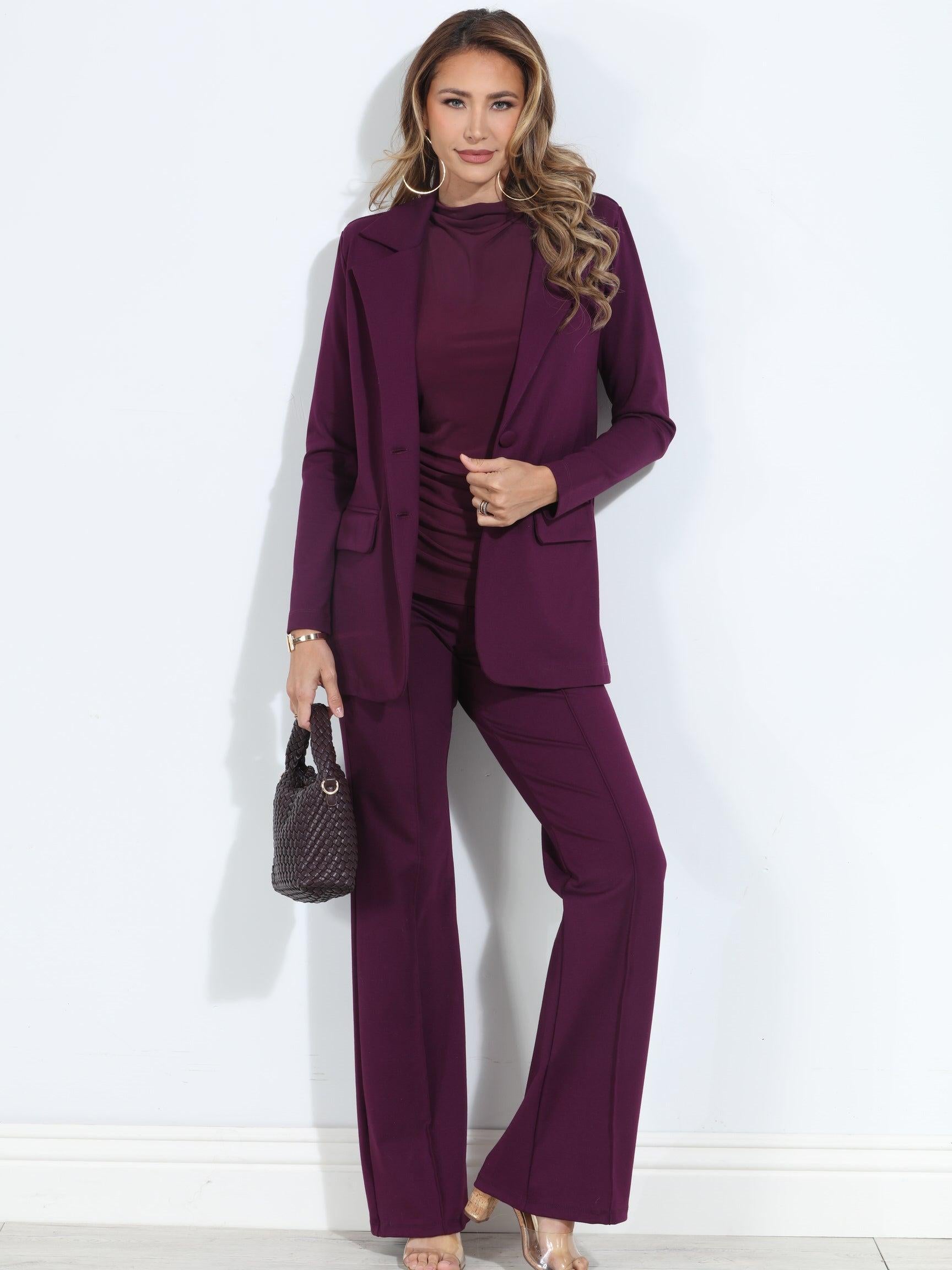 dark purple blazer and pant set on woman holding deep purple purse