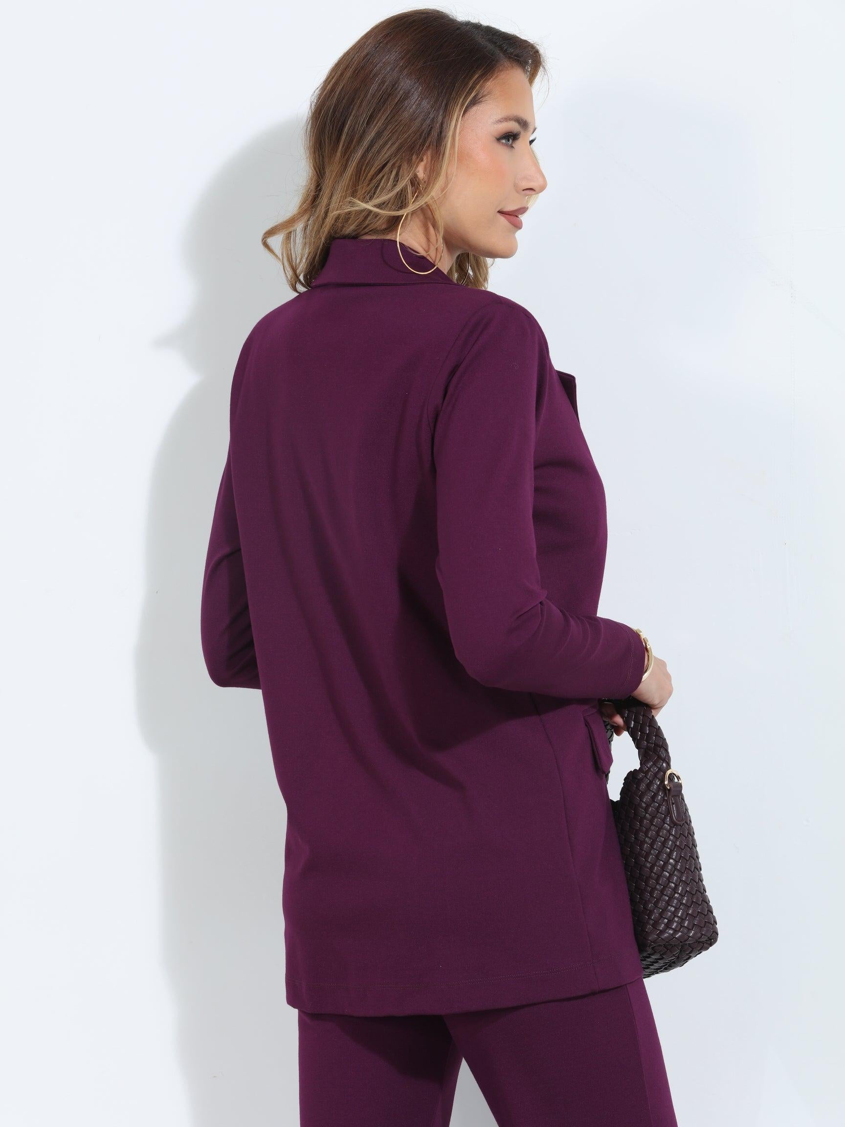back side of dark purple blazer and pant set on woman holding deep purple purse