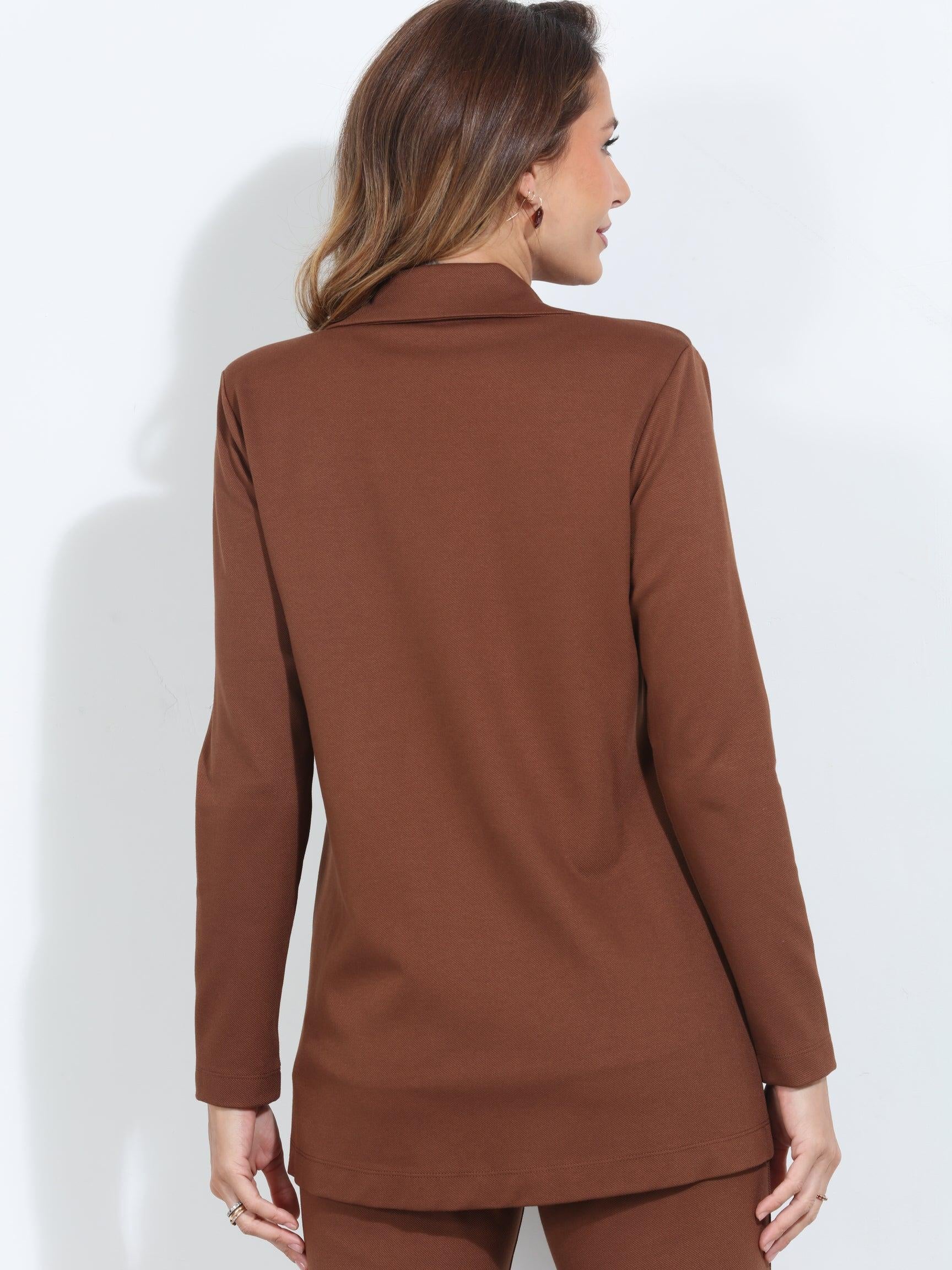 backside of dark orange blazer and pant set on woman