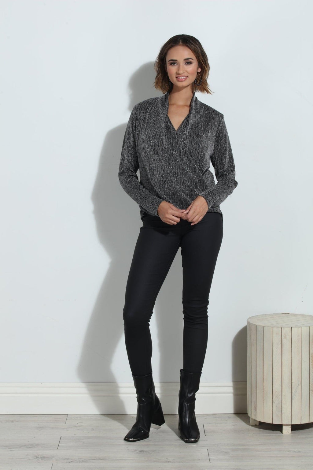 silver and black long sleeve blouse on woman in black pants and black boots