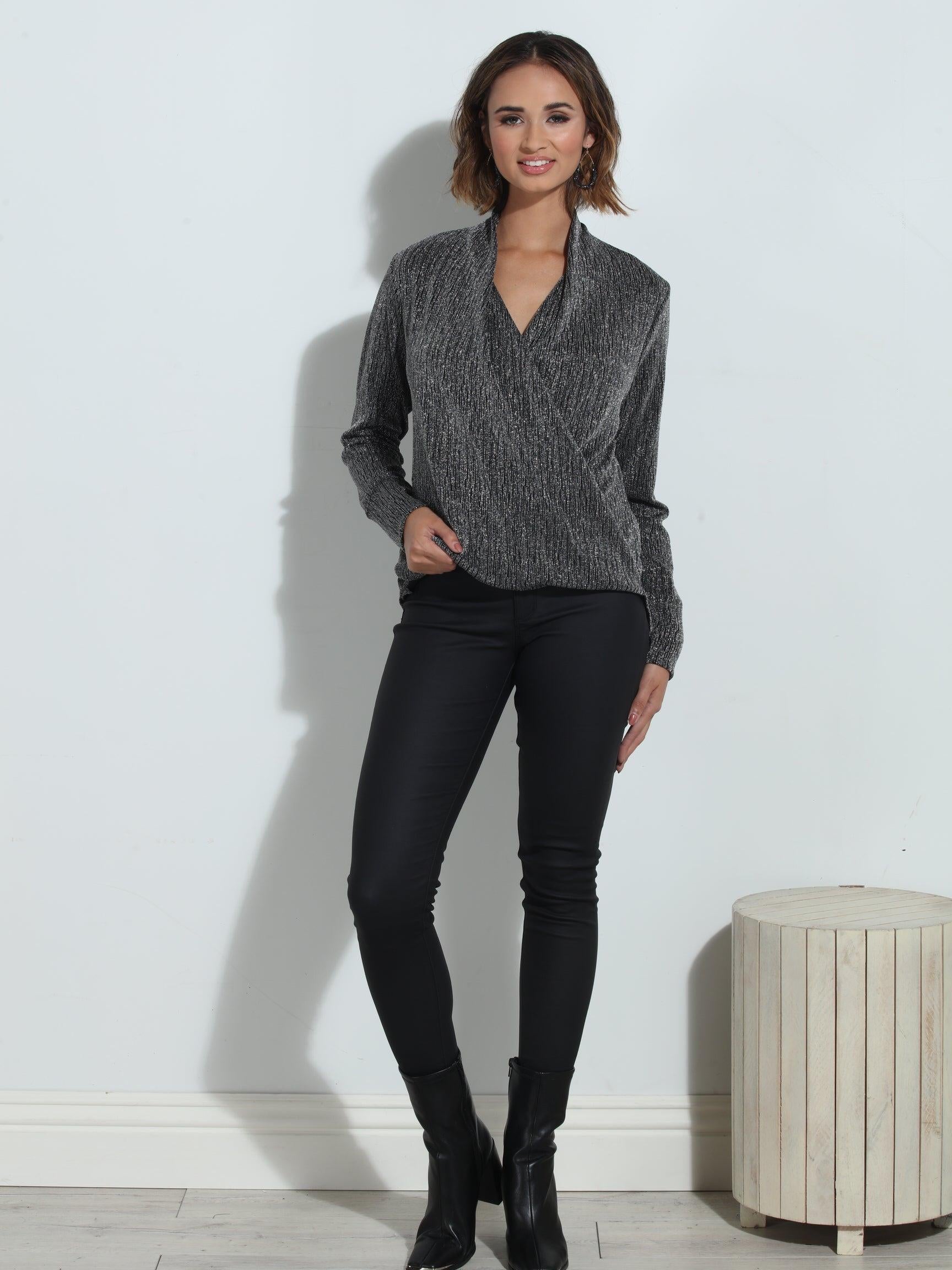 silver and black long sleeve blouse on woman in black pants and black boots