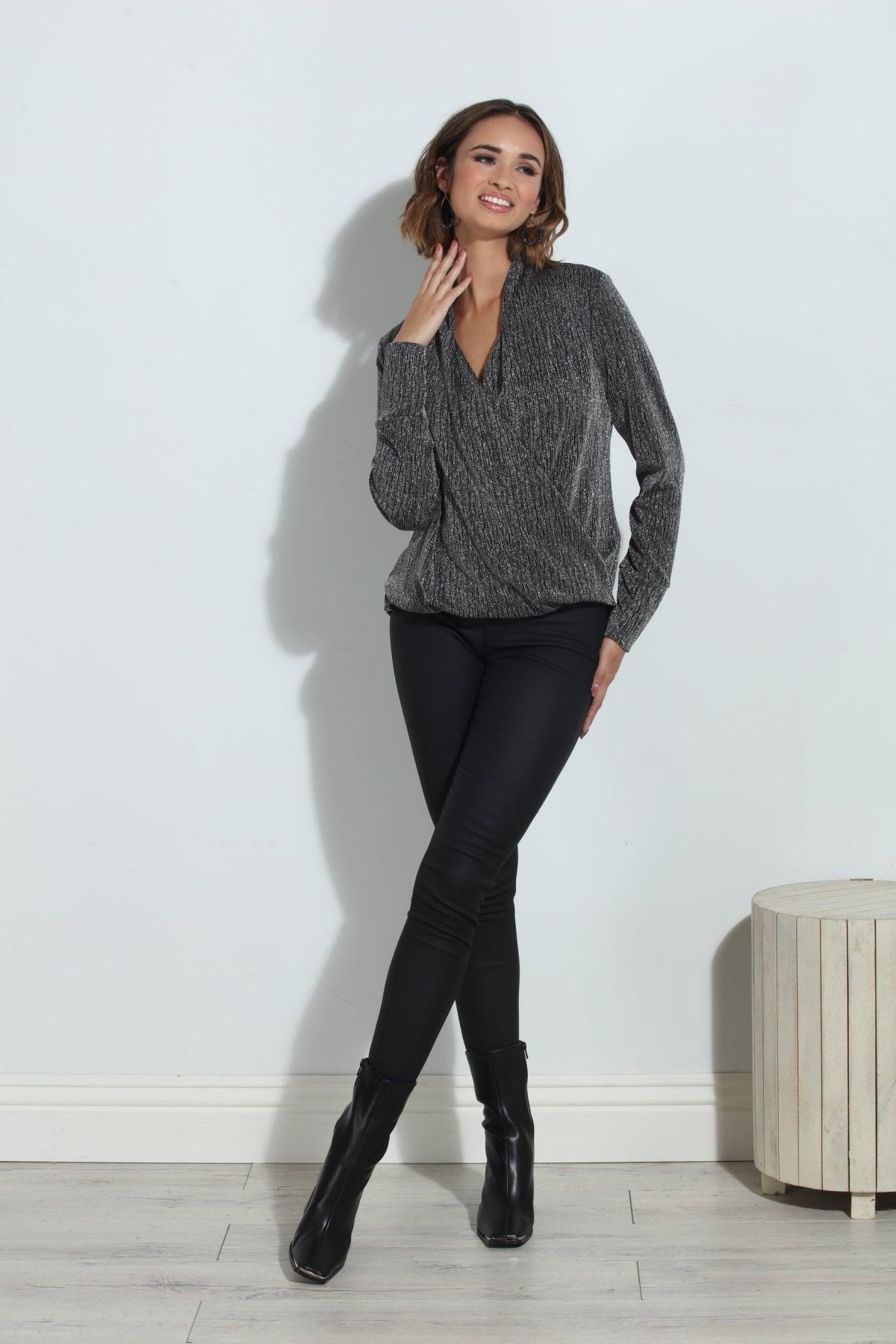 silver and black long sleeve blouse on woman in black pants and black boots