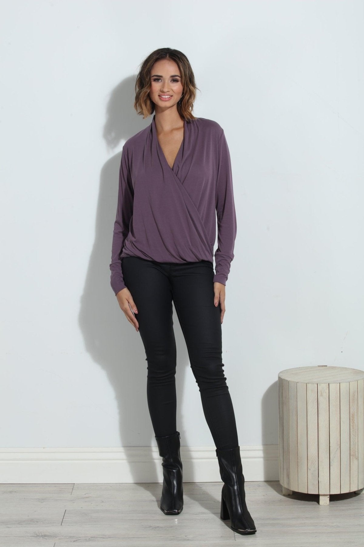 purple long sleeve blouse on woman in black pants and black boots