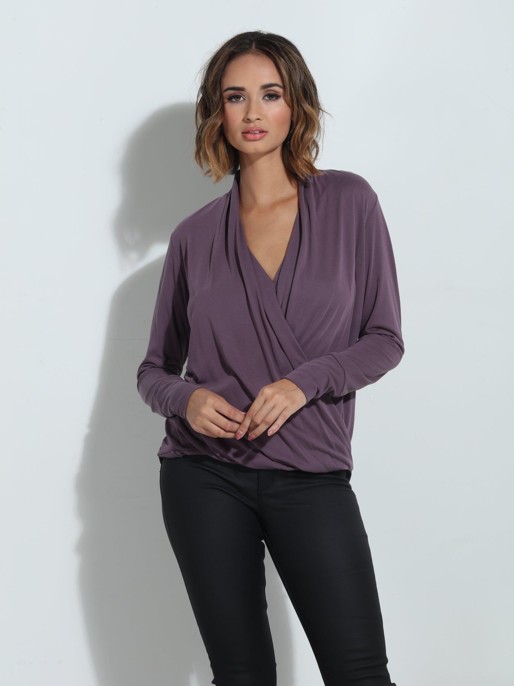 purple long sleeve blouse on woman in black pants
