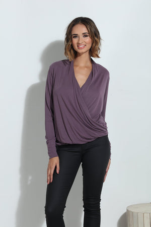 purple long sleeve blouse on woman in black pants