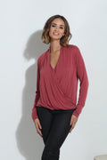 dark mauve long sleeve blouse on woman in dark denim pants