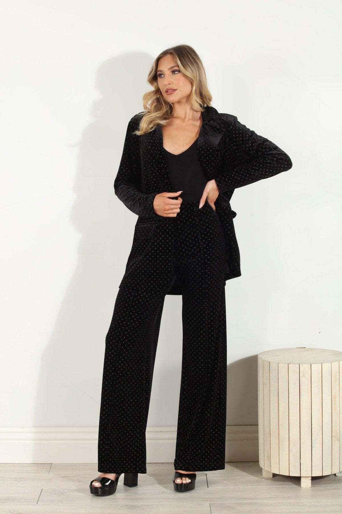 black velvet blazer and pants with shimmer detail styled on woman in black heels