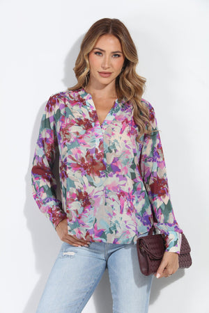 floral multicolored blouse on woman in jeans and holding dark purple blouse