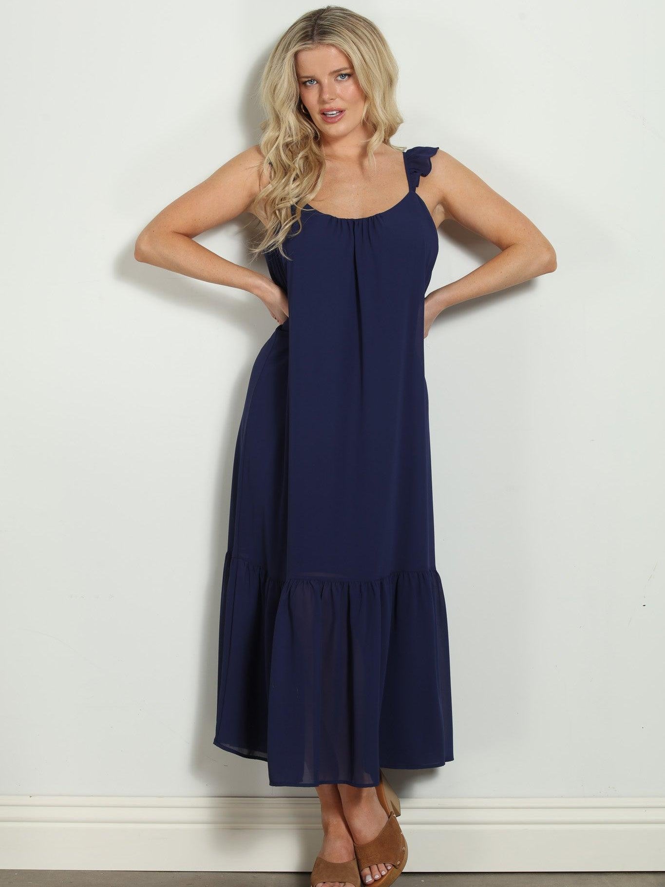 woman in sleeveless navy maxi dress