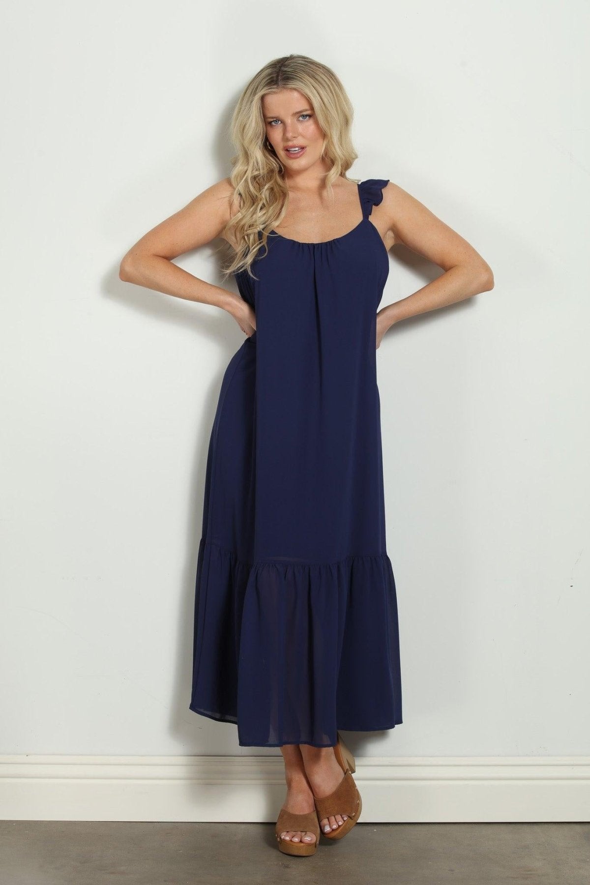 woman in sleeveless navy maxi dress