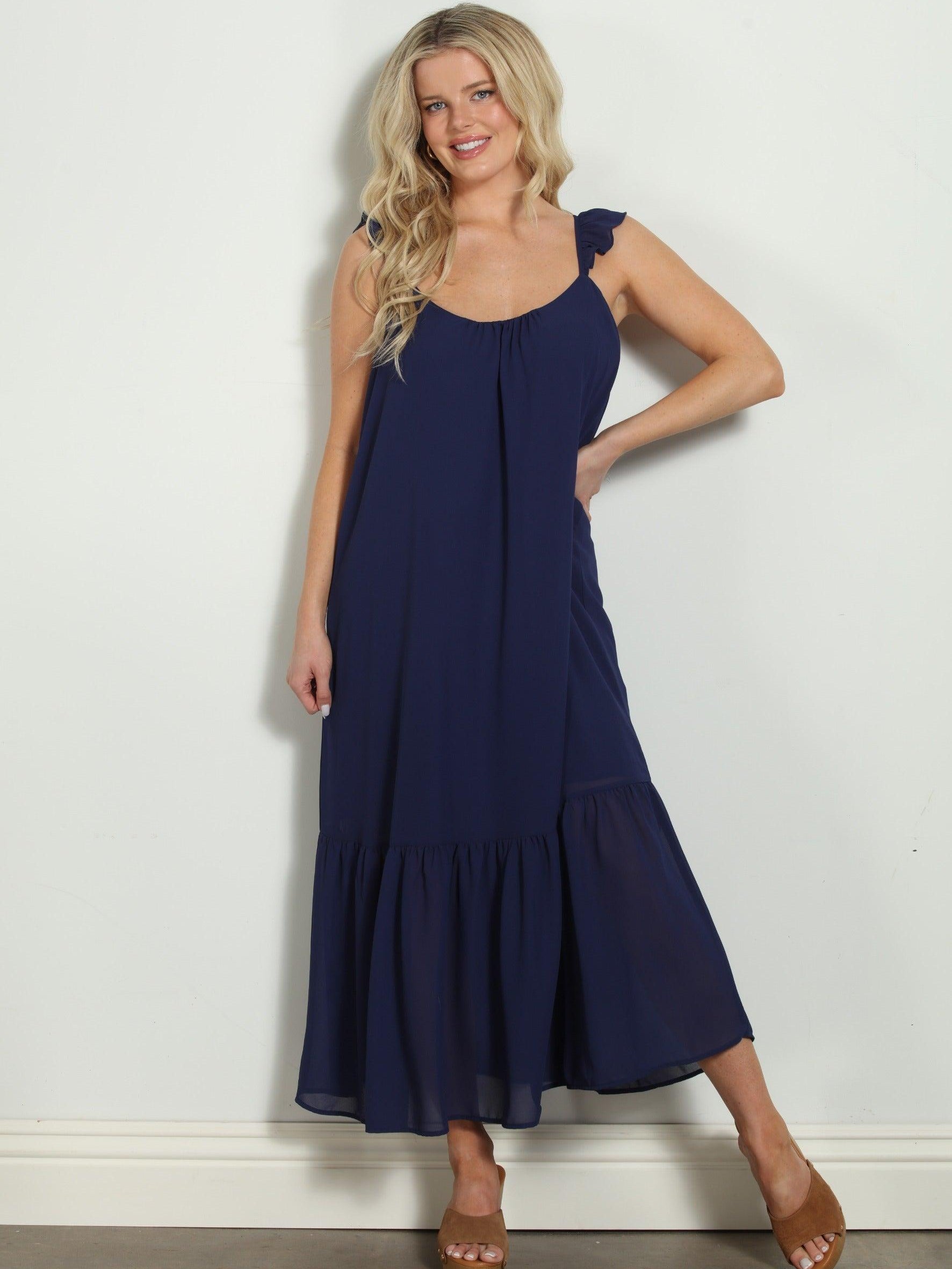 woman in sleeveless navy maxi dress
