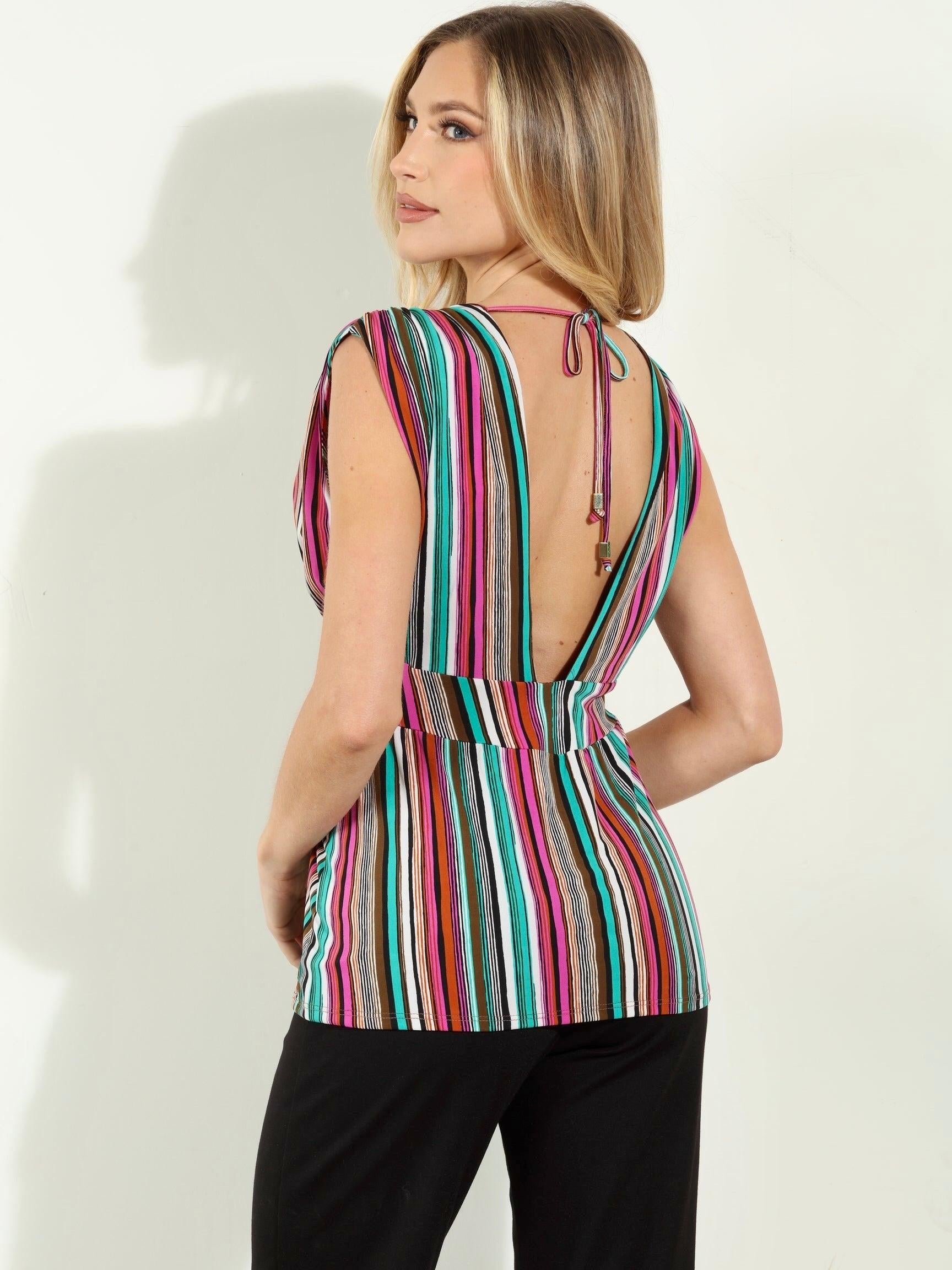backside of woman in multicolored sleeveless blouse and black pants