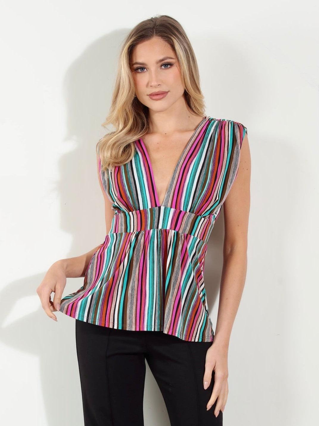 woman in multicolored sleeveless blouse and black pants