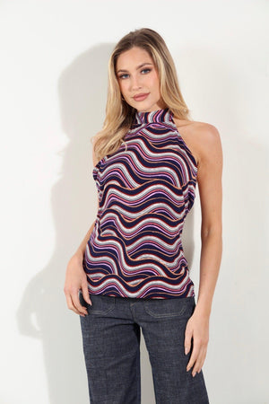 multicolored halter top on woman in denim pants