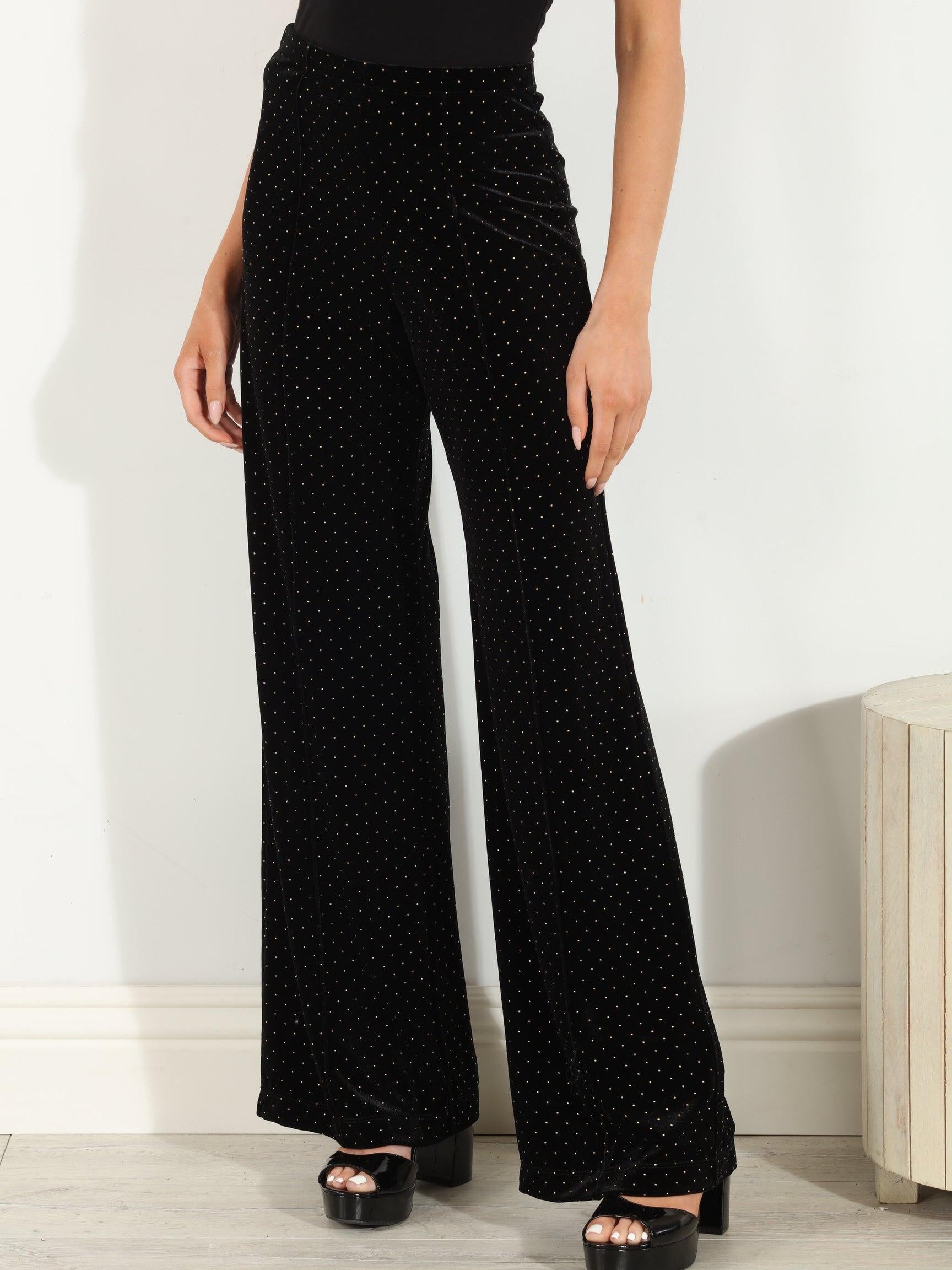 woman in black velvet pants