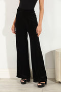 woman in black velvet pants
